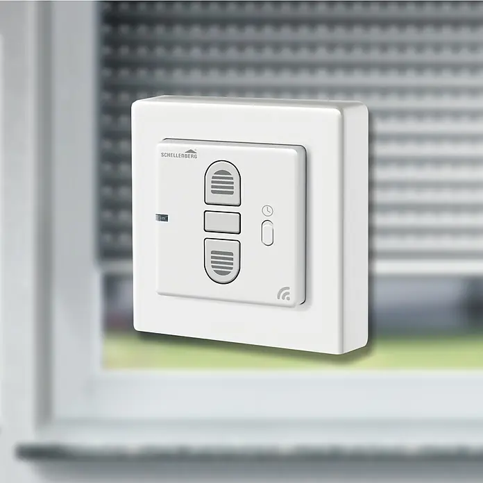 Schellenberg Rollodrive Temporizador inalámbrico - An x L: 50 x 50 mm, Blanco, Específico para: Sistema Smart Home de Schellenberg - Una imagen de un interruptor temporizador Schellenberg para persianas enrollables, montado en una pared. El control es cuadrado y blanco.