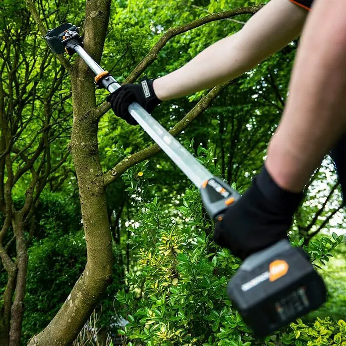 Teleskopstiel - Passend für: Batavia Akku-Kettensäge Nexxsaw V3.1 & V2 - Eine Person bedient eine Akku-Astsäge im Garten, um Äste zu schneiden.