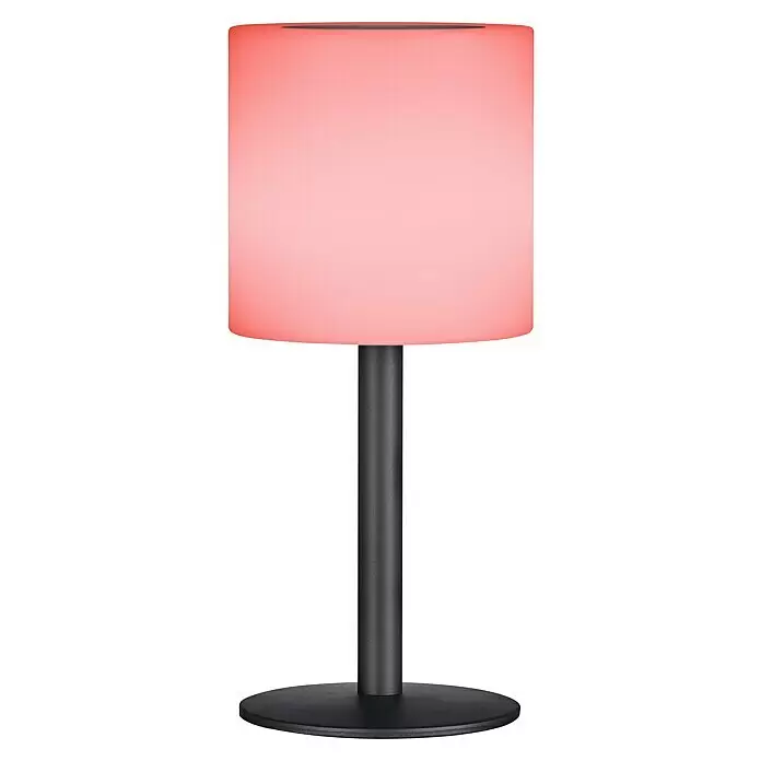 FHL easy Akku-Tischleuchte LESINA Solar - 0,5 W, L x B x H: 13 x 13 x 30 cm, Sandschwarz, RGB, Solarbetrieben - Rosafarbene leuchtende Tischlampe mit schwarzem zylindrischem Ständer und rundem Fuß.