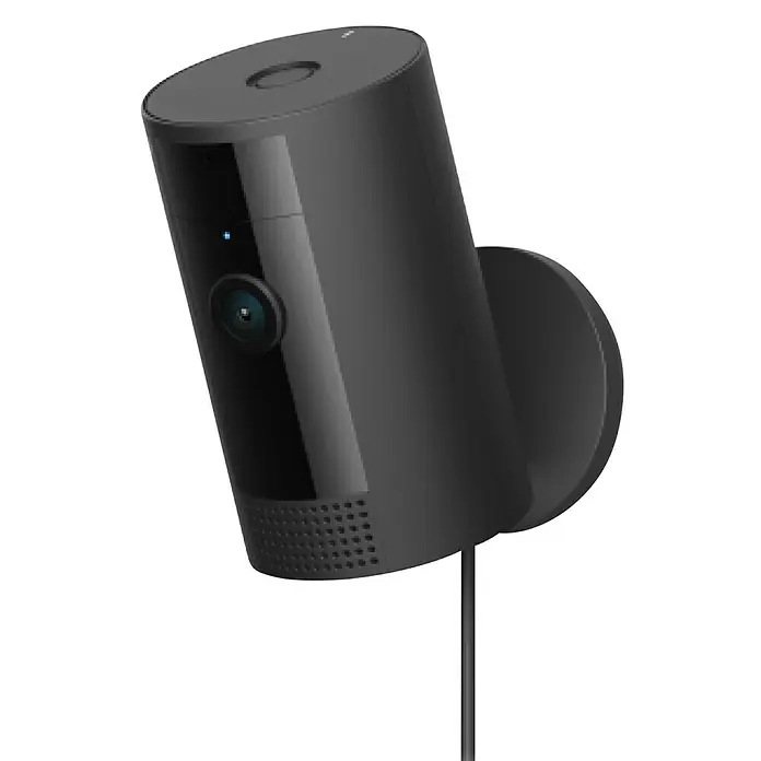 Ring Innenkamera Indoor Cam 2. Gen. - 1.080 Pixel (Full HD), Schwarz, 1 Stk. - Nahaufnahme einer zylinderförmigen Überwachungskamera von Ring mit blauer LED und Montagehalterung auf schwarzem Hintergrund.