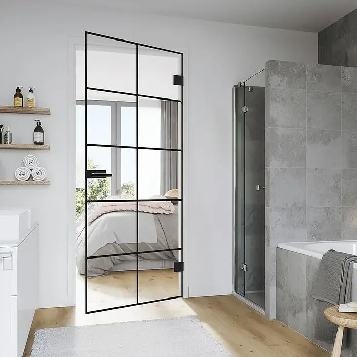 Diamond Doors Black Edition Glasdrehtür Loft - 834 x 1.972 mm, DIN Rechts, Klarglas - Ein elegantes Badezimmer mit einer modernen Duschtür aus Glas mit schwarzen Rahmen. Die Duschtür verleiht dem Raum einen Hauch von Luxus.