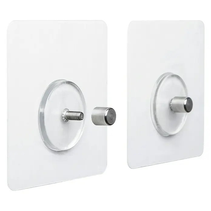 Tatay Kit de fijación Quick Fix - Transparente - Primer plano de dos ganchos de pared transparentes autoadhesivos con pomos cilíndricos plateados, uno desmontado, para montaje en pared.