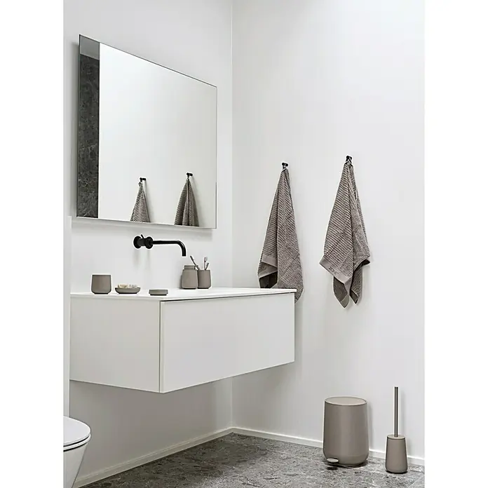 Zone Denmark Nova One Kosmetikeimer - 3 l, Kunststoff, Taupe - Ein Badezimmer mit einem weißen Waschtisch, einem Spiegel, Handtüchern und grauen Badaccessoires, die ein elegantes und modernes Ambiente schaffen.