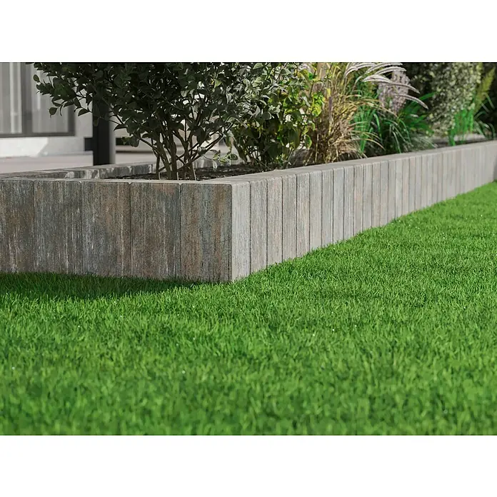 Diephaus Palisade / Mauerstein Laredo Meso40 x 12,5 x 12,5 cm, Muschelkalk, Beton - Nahaufnahme eines erhöhten Gartenbeets mit grauen Steinbegrenzungen und üppigem grünen Rasen, der eine gepflegte Außenanlage zeigt.
