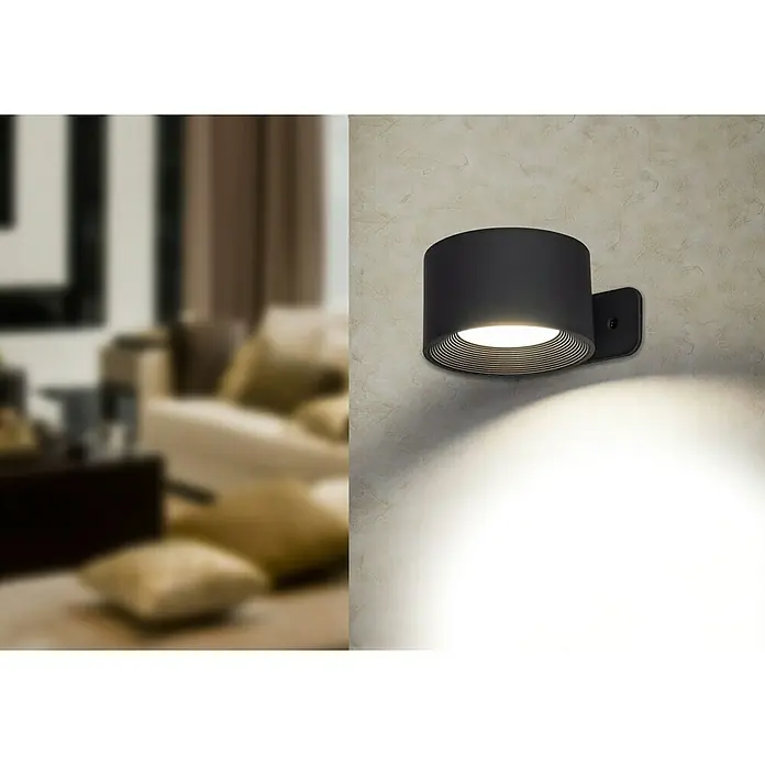 Lavida Aplique de pared con batería Novara - L x An x Al: 9,25 x 7,6 x 4,5 cm, 2 W, Negro, Multicolor, Redonda - Primer plano de una moderna lámpara de pared negra, que emite una luz brillante, agregando un toque de estilo a cualquier habitación.
