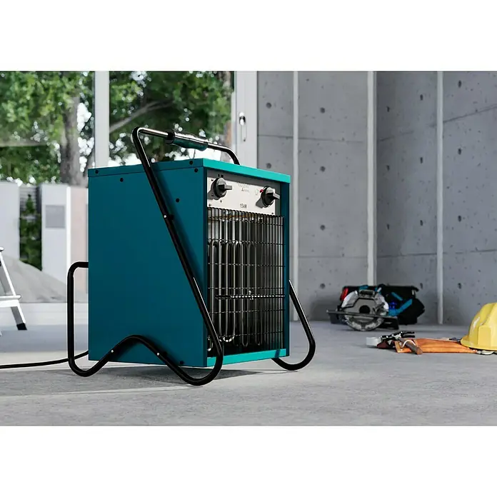 Voltomat HEATING Bauheizer - 15.000 W, Nennspannung: 400 V, Blau, IP24 - Das Bild zeigt eine blaue Heizung mit schwarzem Griff und Gitter vor einem Betonhintergrund. Es ist eine tragbare Heizung für Baustellen.