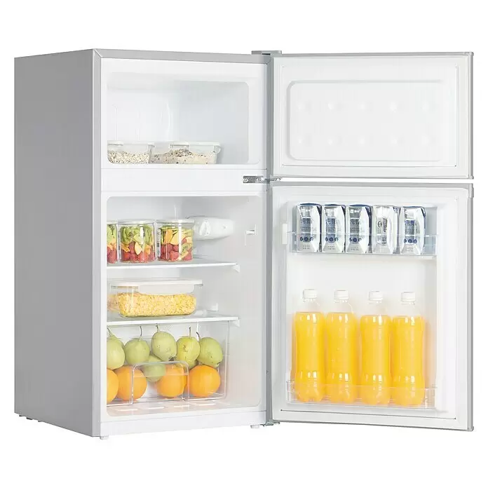 PKM Kühl-Gefrierkombination GK88EIX - Nutzinhalt Gesamt: 84 l, 49,2 x 45,3 x 85,1 cm, Inxo-Design - Silberner Kompaktkühlschrank mit zwei Türen, Gefrier- und Kühlfach gefüllt mit Lebensmitteln und Getränken.