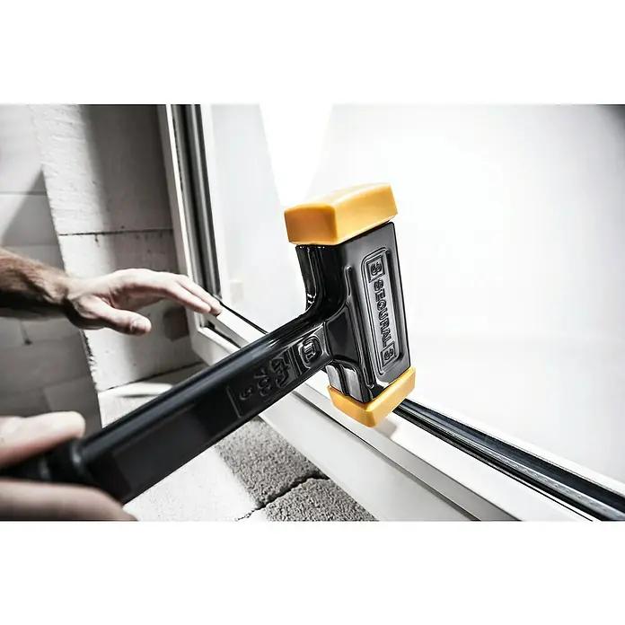 Halder Secural Schonhammer - Maße Kopf: 30 x 40 mm, Mittelhart - Nahaufnahme eines schwarzen SECURAL Gummihammers mit gelben Enden, der für Bauarbeiten verwendet wird.
