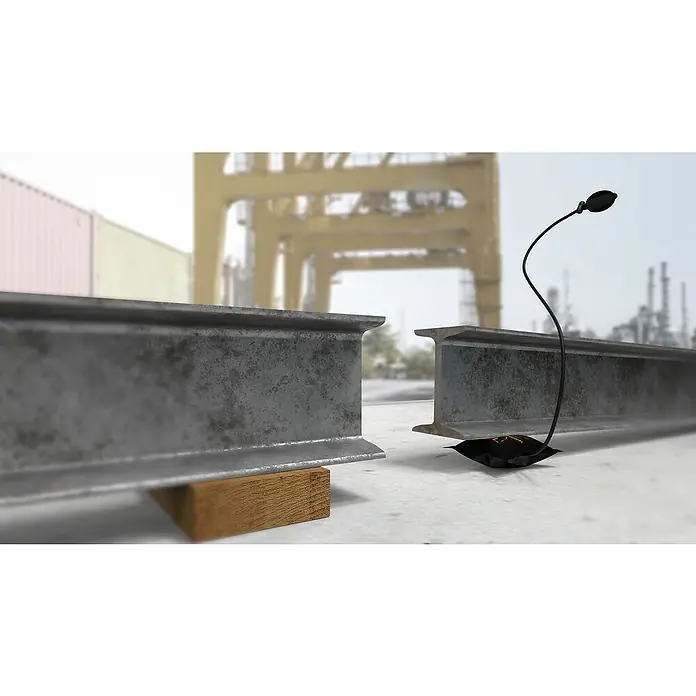 Montagekissen Winbag Max - Traglast: 250 kg - Illustration eines schwarzen, biegbaren Ständers mit einem Licht, das unter einem Stahlträger befestigt ist, der auf einem Betonboden steht.