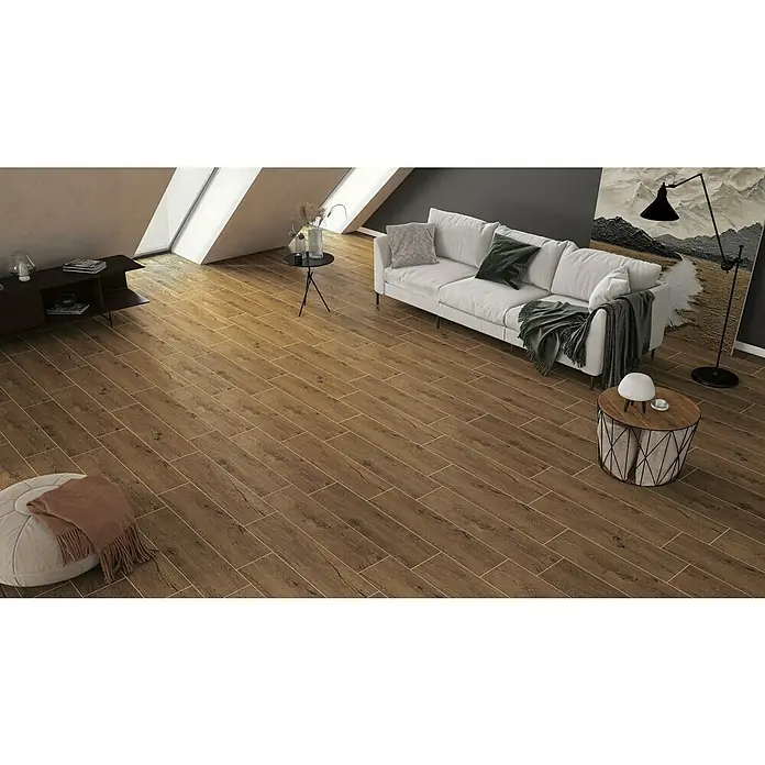 Atlas Concorde Solution Fable Feinsteinzeugfliese Cognac - 22,5 x 90 cm, Dunkelbraun, Matt - Das Bild zeigt eine moderne Diele mit Holzboden, einem hellen Sofa und stilvollen Deko-Elementen, die ein gemütliches Ambiente schaffen.