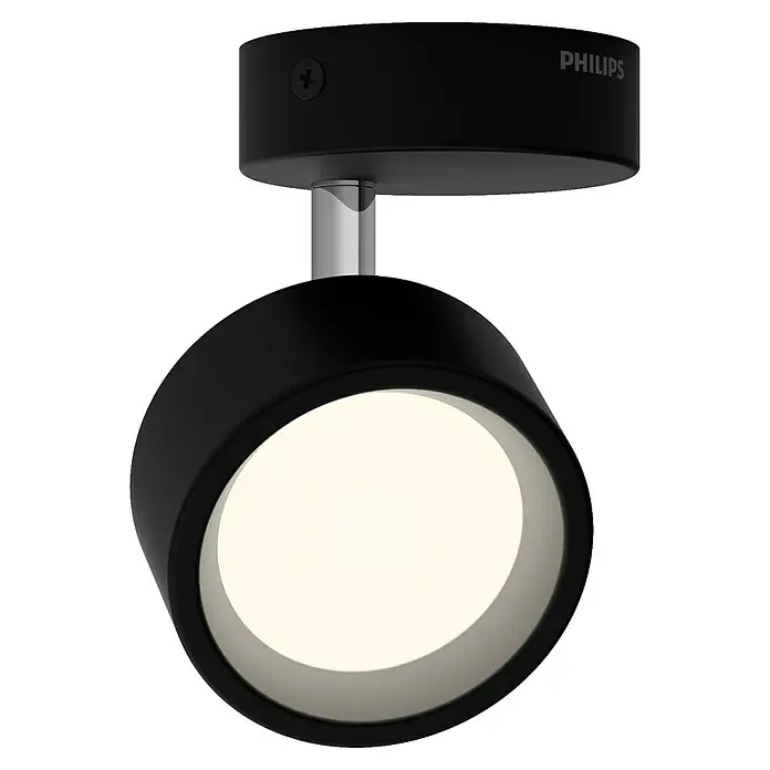 Philips Regleta LED Bracia - 5,5 W, L x An x Al: 9 x 9 x 12,5 cm, Negro, Blanco cálido, 1 ud. - Primer plano de un foco LED de techo Philips negro con un conector plateado, emitiendo una luz cálida y brillante.