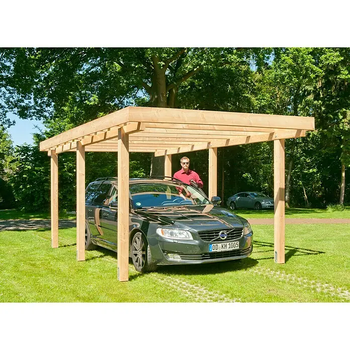 Kiehnholz Carport - Außenmaß inkl. Dachüberstand (B x T): 304 x 510 cm, Holz, Carport geeignet für: PKWs - Ein Holzcarport mit einem schwarzen Volvo darunter, auf einer grünen Wiese mit einem Mann daneben.