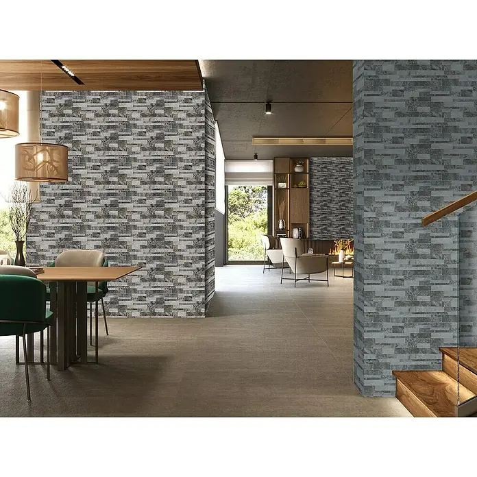 Verblendstein Durango Jet 8 - 50 x 33,3 cm, Hellgrau, Natursteinoptik - Ein moderner Raum mit einer Akzentwand aus grauen Ziegeln und passenden Bodenfliesen, der eine stilvolle und harmonische Atmosphäre schafft.