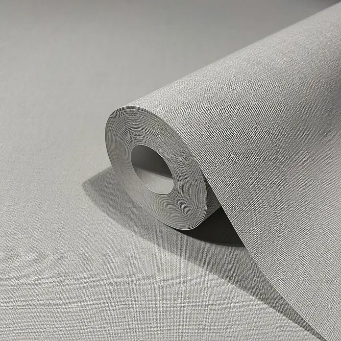 Marburg GZSZ Vliestapete - Grau, Uni, 10,05 x 0,53 m - Nahaufnahme einer Rolle grauer, strukturierter Tapete, die Textur und das dezente Design des Produkts hervorhebt.