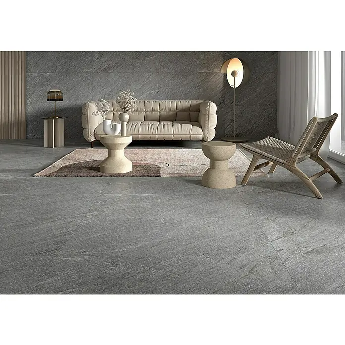 Feinsteinzeugfliese Piazza Grey - 59,7 x 59,7 cm, Grau, Matt - Einrichtung mit einem beigen Sofa, stilvollen Beistelltischen und einem eleganten Sessel auf einem grauen Steinboden.