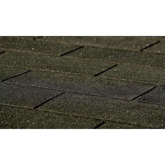 Weka Schutzfolie - 9 Stk. - Nahaufnahme von dunklen, körnigen Asphalt-Dachschindeln mit subtil glitzernden Sprenkeln und sichtbaren Überlappungen, die Schattenlinien bilden.