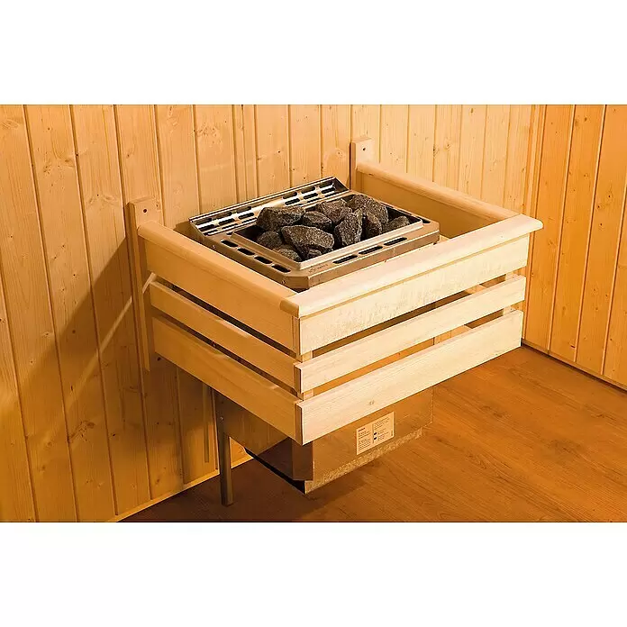 Weka Ofenschutzgitter - 48 x 60 cm - Saunaofen mit Metallgehäuse und Steinen, umgeben von einem hellen Holzschutzgitter, in einer Holzsauna installiert.