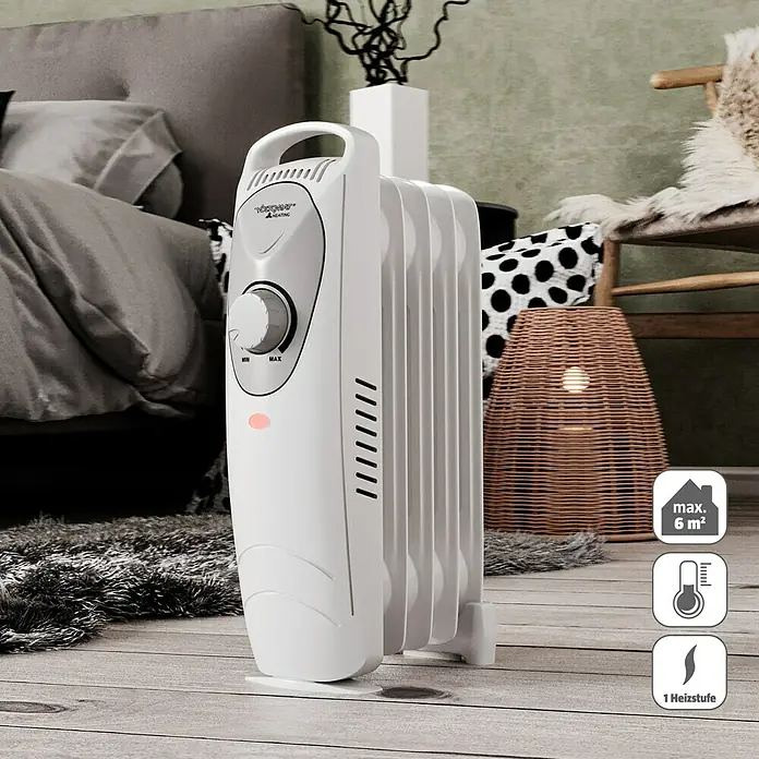 Voltomat HEATING Ölradiator Mini - 600 W, Raumgröße bis ca. 6 m², Weiß - Abbildung eines weißen Heizkörpers auf einem Holzboden, der eine gemütliche und warme Atmosphäre erzeugt.