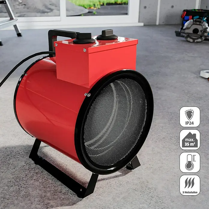 Voltomat HEATING Bauheizer - Passend für: Raumgröße bis ca. 35 m², 1.000 W - 3.000 W, Nennspannung: 220 V - 240 V, Rot, IP24 - Das Bild zeigt einen roten, zylinderförmigen Elektroheizer mit schwarzem Gitter und Bedienelementen auf einer grauen Betonoberfläche.