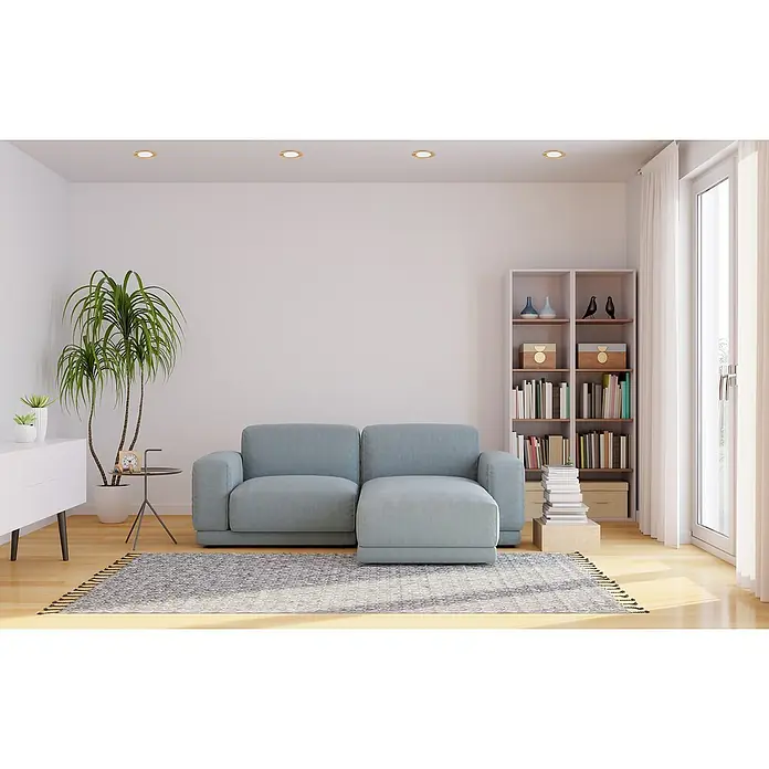 Alverlamp Downlight empotrable LED redondo Nordic - 6 W, Madera, Ø x Al: 12 cm x 15 mm, Blanco Neutro - Una escena minimalista de sala de estar con un sofá azul claro, una librería y una planta de interior, evocando un ambiente sereno y acogedor.