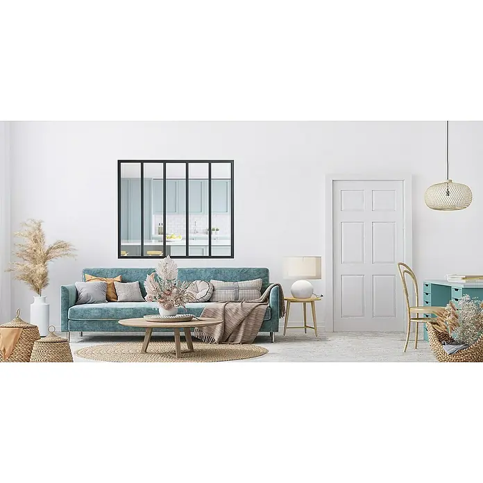 Kit atelier Glastrennwand Loft Atelier - 1.532 x 1.300 mm, Einscheibensicherheitsglas (ESG) - Ein Wohnzimmer mit einem türkisfarbenen Sofa, einem Couchtisch und einem Spiegel, der eine Küche reflektiert, vermittelt ein Gefühl von modernem Komfort.