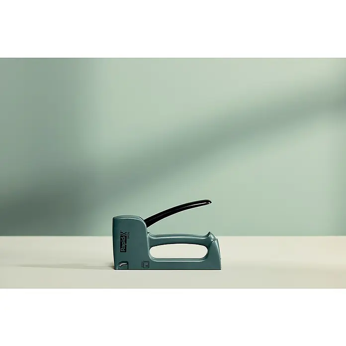 Rapid Handtacker - Feindrahtklammer Typ 53, 4 mm - 10 mm, Grün - Nahaufnahme eines grünen Rapid Skog-Tackers auf einem Tisch vor einem unscharfen, hellgrünen Hintergrund.