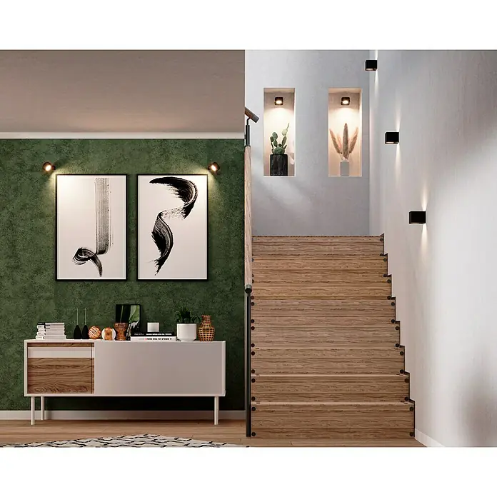 Lavida Akku-Wandleuchte Mirano - L x B x H: 9,25 x 7,65 x 4,5 cm, 2 W, Schwarz, Mehrfarbig, Eckig - Eine moderne Inneneinrichtung mit einer Kommode, zwei abstrakten Kunstwerken und einer Treppe mit Holzstufen.