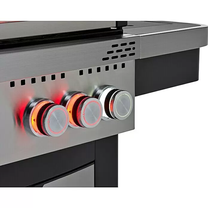 Grandstate Gasgrill Hawk 411 - Grillfläche (B x T): 71 x 49 cm, 15,2 kW, Anzahl Brenner: 4 Stk. - Nahaufnahme eines Edelstahlgrills mit drei beleuchteten Bedienknöpfen, zwei rot und einer weiß leuchtend, und Lüftungsschlitzen.
