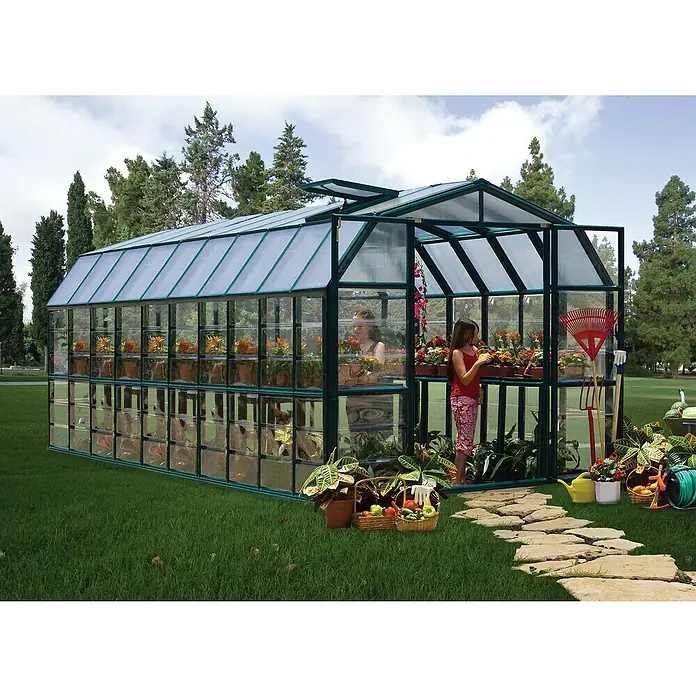 Palram – Canopia Invernadero Grand Gardener - Medidas ext. (An x Pr): 264,7 x 637,3 cm, Material de la pared lateral: Plástico, 0,8 mm, Verde - Un invernadero de vidrio con plantas y dos personas. Es un lugar encantador para jardinear y relajarse en este invernadero.