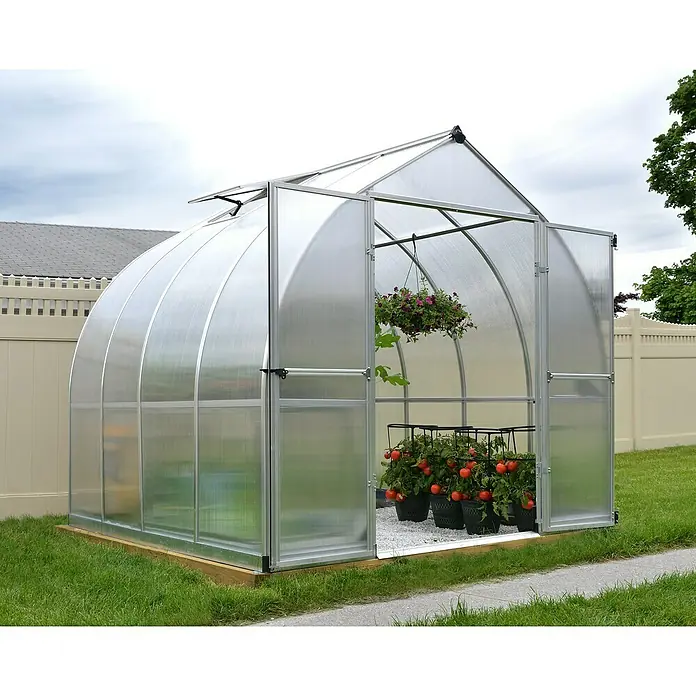 Palram – Canopia Invernadero Bella - Medidas ext. (An x Pr): 244 x 244 cm, 6 mm, Plateado - La imagen muestra un invernadero con plantas en su interior. El invernadero está hecho de material transparente y tiene una estructura de marco plateado.