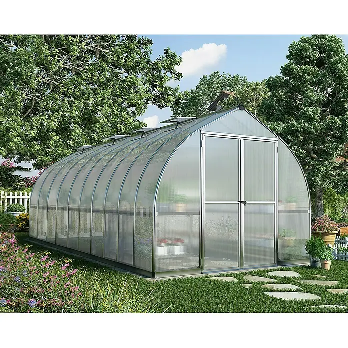 Palram – Canopia Invernadero Bella - Medidas ext. (An x Pr): 244 x 604 cm, 6 mm, Plateado - Un gran invernadero con cubierta transparente y puertas dobles, rodeado de exuberante vegetación. Ideal para jardineros aficionados.