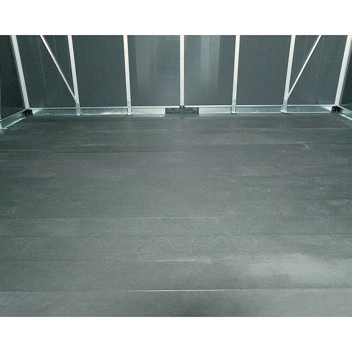 Palram – Canopia Caseta de jardín con suelo Yukon - Medidas ext. (An x Pr): 332 x 519 cm, Plástico, Antracita - Interior de un invernadero con un revestimiento de suelo gris y soportes metálicos robustos para el cultivo de plantas.