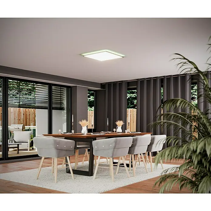 Tween Light LED-Panel RGB-RC-CCT-DIM - 32,5 W, L x B x H: 59,5 x 59,5 x 5,5 cm, Weiß, RGBW - Helles Interieur mit einem modernen quadratischen Deckenlicht über einem Esstisch mit grauen Stühlen und Blick ins Grüne.
