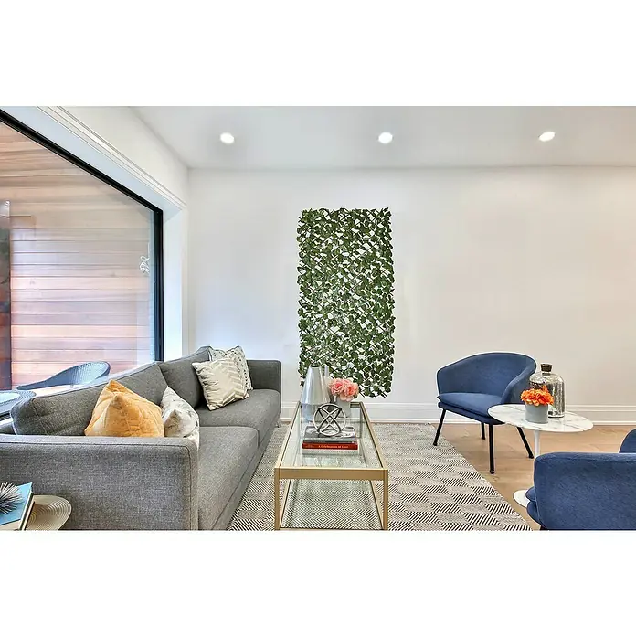 Faura Celosía extensible Mimbre con Hojas de Laurel - 2 x 1 m, Verde - Sala de estar con sofá gris, sillones azules, mesa de centro y panel decorativo de pared verde.