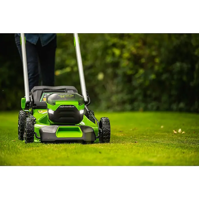 Greenworks 60V Akkusystem Akku-Rasenmäher GD60LM46SP - 60 V, 1 Akku, 4 Ah, Schnittbreite: 46 cm - Ein grüner Rasenmäher mit Akku, der auf einem Rasen steht und von einer Person bedient wird.