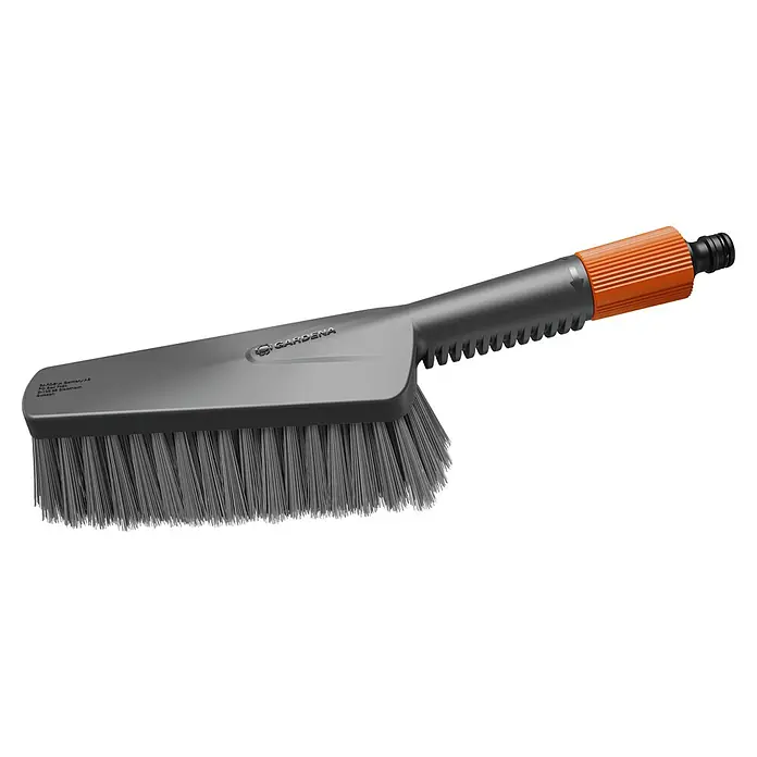 Gardena Handbürste Cleansystem M soft - Wasserführend - Eine Nahaufnahme einer GARDENA Waschbürste mit Wasseranschluss, ideal für die Reinigung im Außenbereich. Der Bürstenkopf ist grau, der Griff ist orange.