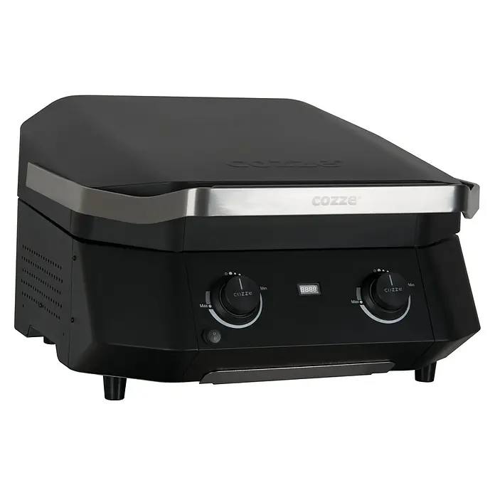 Cozze Barbacoa eléctrica E 500 - Superficie de la parrilla (An x Pr): 51 x 39 cm, 2,1 kW, Negro - Primer plano de una parrilla Cozze, que se distingue por su diseño negro y acentos plateados. Son visibles dos botones de control para la regulación de la temperatura.