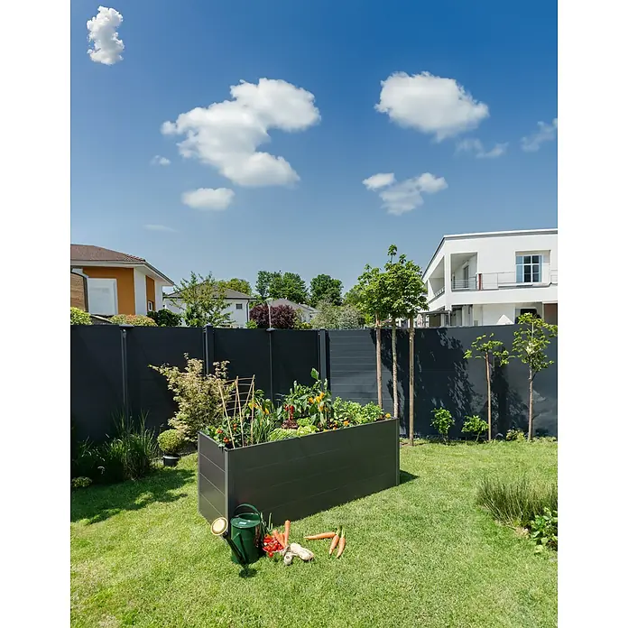 Guardi Hochbeet - 140 x 70 x 76 cm, Metall, Anthrazit - Ein erhöhter Gartenkasten mit Gemüse und Werkzeugen in einem grünen Garten unter blauem Himmel.