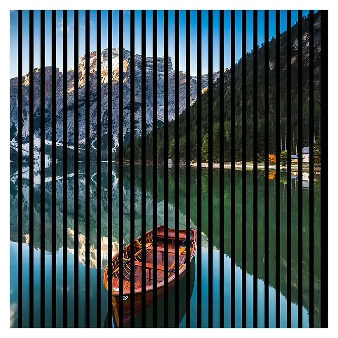 Profiles and more Akustikpaneel Dolomiten - 1.195 x 1.133 x 19 mm - Malerische Ansicht eines hölzernen Ruderboots auf einem ruhigen See, umgeben von Bergen und Wäldern, in Streifen unterteilt.