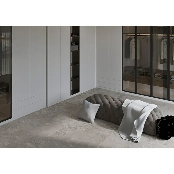 Feinsteinzeugfliese Camarque - 100 x 100 cm, Grau, Matt - Einrichtungsidee für ein modernes Schlafzimmer mit grauen Kleiderschränken, einem gepolsterten Hocker und einer weißen Decke im minimalistischen Stil.