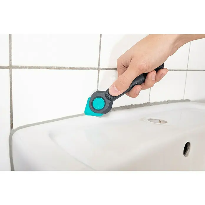 Wolfcraft Rascador de juntas - 4 pzs. - Herramienta de limpieza de lechada que se utiliza en el borde de un fregadero. La herramienta tiene un mango negro y una punta turquesa.