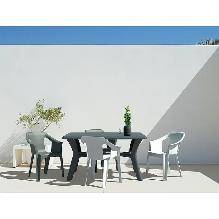 Mesa de jardín Tulipan - L x An x Al: 140 x 90 x 74 cm, Polipropileno, Antracita - Una mesa de jardín gris con cuatro sillas en un entorno tranquilo y minimalista. Perfecto para relajarse al aire libre.
