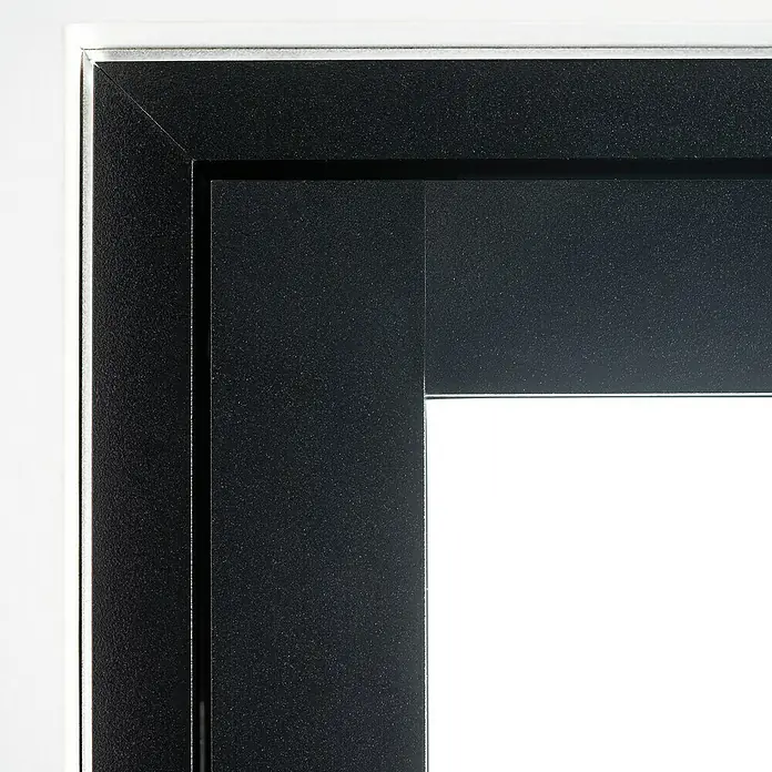 Room Plaza Loft + Mehr Drehtür-Komplettset - 1.000 x 2.130 mm, DIN Anschlag: Links, Klarglas - Detailaufnahme eines modernen schwarzen Fensterrahmens mit silbernen Akzenten, der ein minimalistisches Design und hochwertige Verarbeitung zeigt.