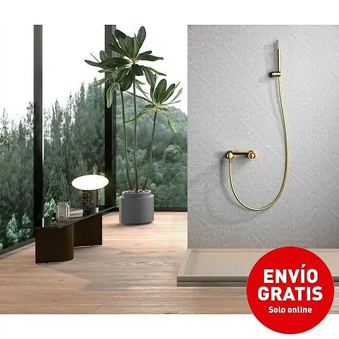 Imex Olimpo Grifo de ducha - Oro - Imagen de un baño con un conjunto de ducha dorado sobre una pared de mármol gris. Un logo de "Envío Gratis" está en primer plano.