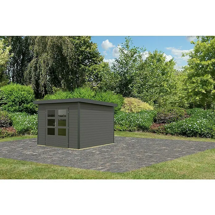 Karibu Gartenhaus Pluto 6 B - Außenmaß inkl. Dachüberstand (B x T): 309 x 292,4 cm, Holz, Terragrau/ Anthrazit - Eine graue Gartenhütte mit Doppeltüren steht auf einer gepflasterten Fläche, umgeben von üppigem Grün. Perfekt für die Gartenaufbewahrung.