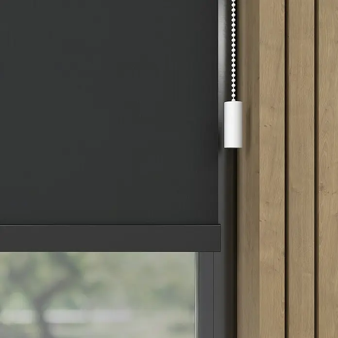 Verdunkelungsrollo Mila Elektrisch - B x H: 80 x 190 cm, Schwarz, Uni - Eine Nahaufnahme eines schwarzen Rollos mit einem weißen Zugschnur vor einer Holzwand, die eine elegante Fensterdekoration zeigt.
