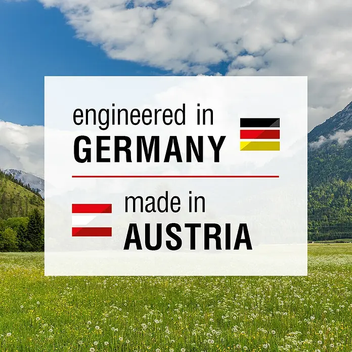 AL-KO Comfort Benzin-Rasenmäher 51.0 SP-A - 2,1 kW, 139 cm³, Schnittbreite: 51 cm - Auf dem Bild steht „Entwickelt in Deutschland, hergestellt in Österreich“ mit den jeweiligen Landesflaggen vor einem Naturbild.