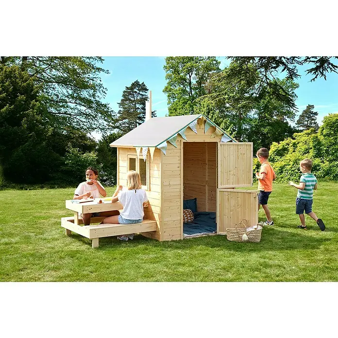 Soulet Spielhaus Tiana - L x B x H: 221 x 127 x 162 cm, Holz - Kinder spielen in einem hölzernen Spielhaus im Garten, das mit einer Picknickbank und Inneneinrichtung ausgestattet ist.