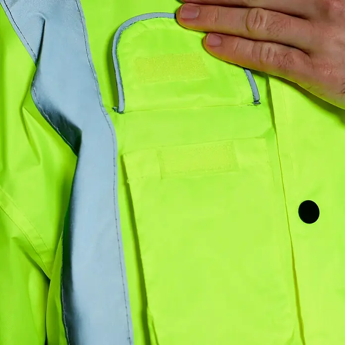 Scheibler Warnschutz-Jacke Blouson - Gelb, XL - Detailaufnahme einer neongelben Sicherheitsjacke mit reflektierenden Streifen und Taschen, die Schutz und Sichtbarkeit bietet.