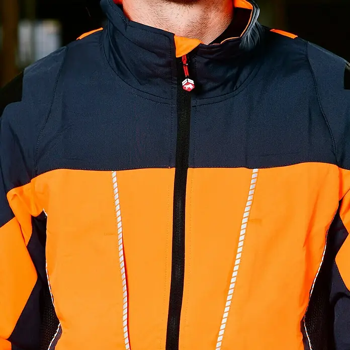 Bullstar Multifunktionsjacke Proximo - Orange/Anthrazit, L - Nahaufnahme einer orange-blauen Arbeitsjacke mit Reißverschluss und reflektierenden Details.